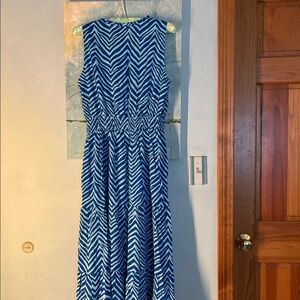Sleeveless summery dress with dark blue/light blue stripes and cinched waist.
